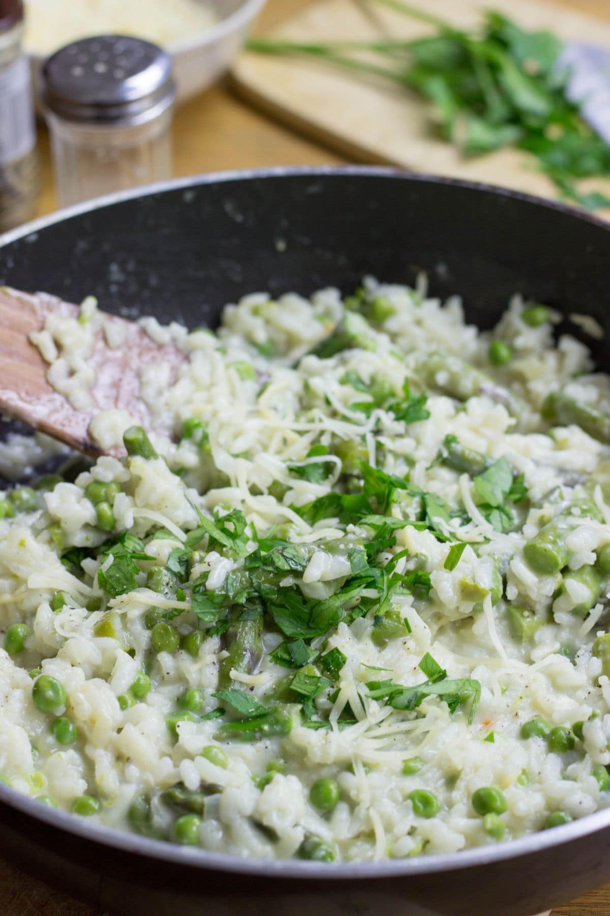 A skillet of risotto with a wooden spoon in it | Hurry The Food Up