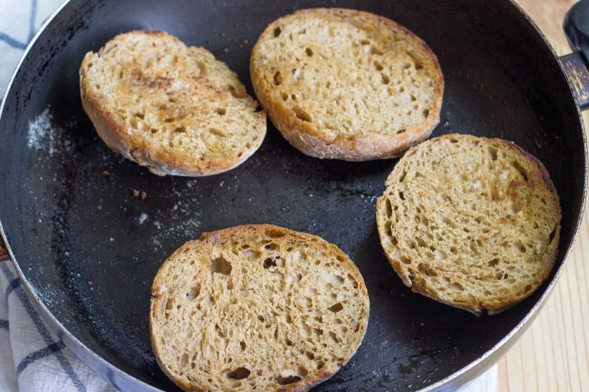 Bread rolls cut in a half, face up in a frying pan | Hurry The Food Up