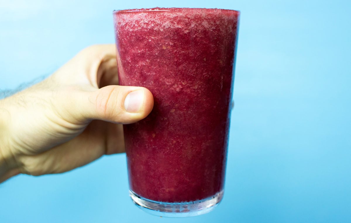 The glass with beetroot smoothie is in someone's hand | Hurry The Food Up