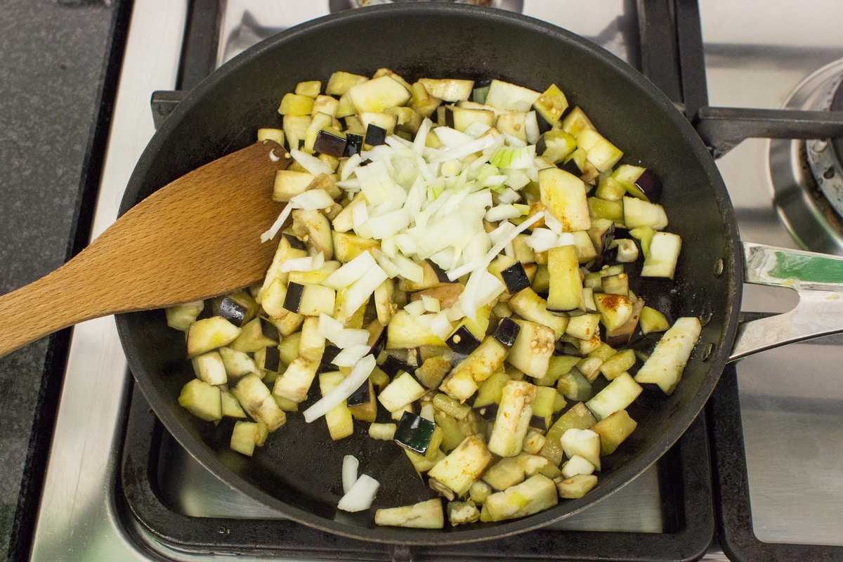 Diced aubergines sauteing in a hot pan with onions | Hurry The Food Up 