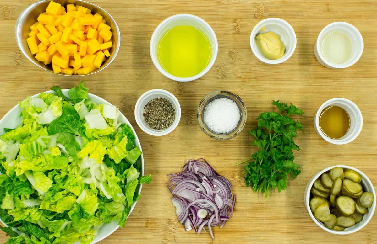 Cheese salad ingredients like lettuce, vinegar, mustard, maple syrup, olive oil, red onion, cheddar cheese, gherkins, parsley etc | Hurry The Food Up