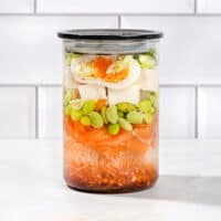 A sealed jar of all the constituent ingredients of an easy homemade ramen noodle soup, on a white surface | Hurry The Food Up - 8