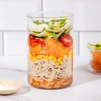 An open jar in the process of being layered with lots of ingredients including zucchini, carrot, salt | Hurry The Food Up - 8
