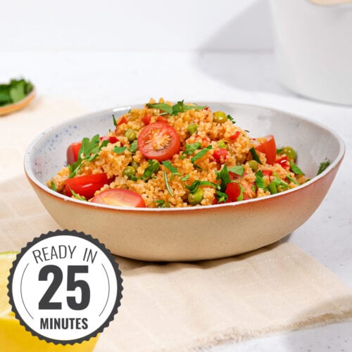 A bowl of couscous and veggies in a bowl, placed on a tea towel with a time stamp in the bottom left hand corner | Hurry The Food Up