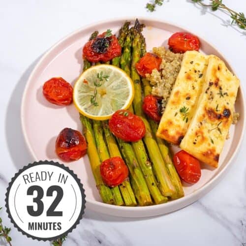 A plate of roast asparagus, halloumi and tomatoes, on a bed of quinoa with a time stamp in the bottom left hand corner | Hurry The Food Up