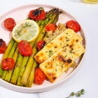 A plate of roast asparagus, halloumi and tomatoes, on a bed of quinoa with a jar of olive oil in shot | Hurry The Food Up - 8