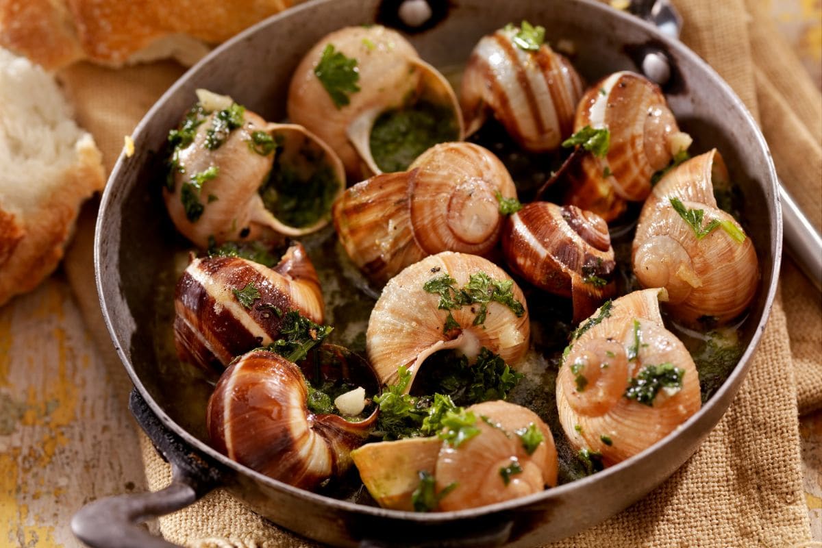 A bowl of escargots in herbs butter and garlic | Hurry The Food Up