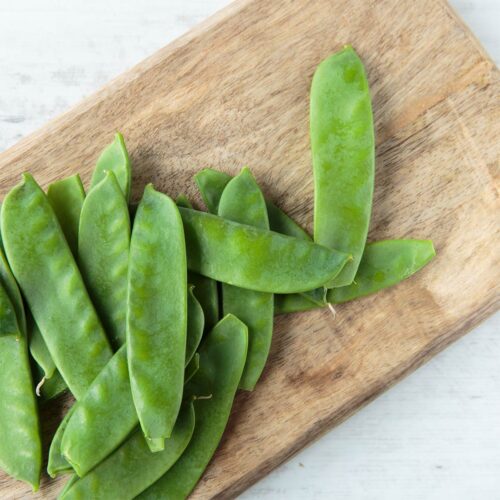Mangetout on a wooden chopping board shot from above | Hurry The Food Up