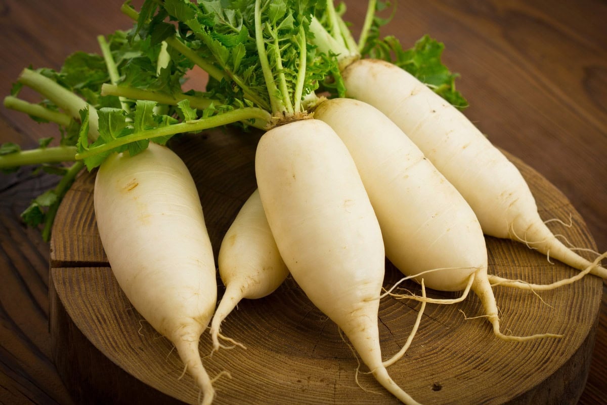 Daikon Radishes are on the wooden surface | Hurry The Food Up