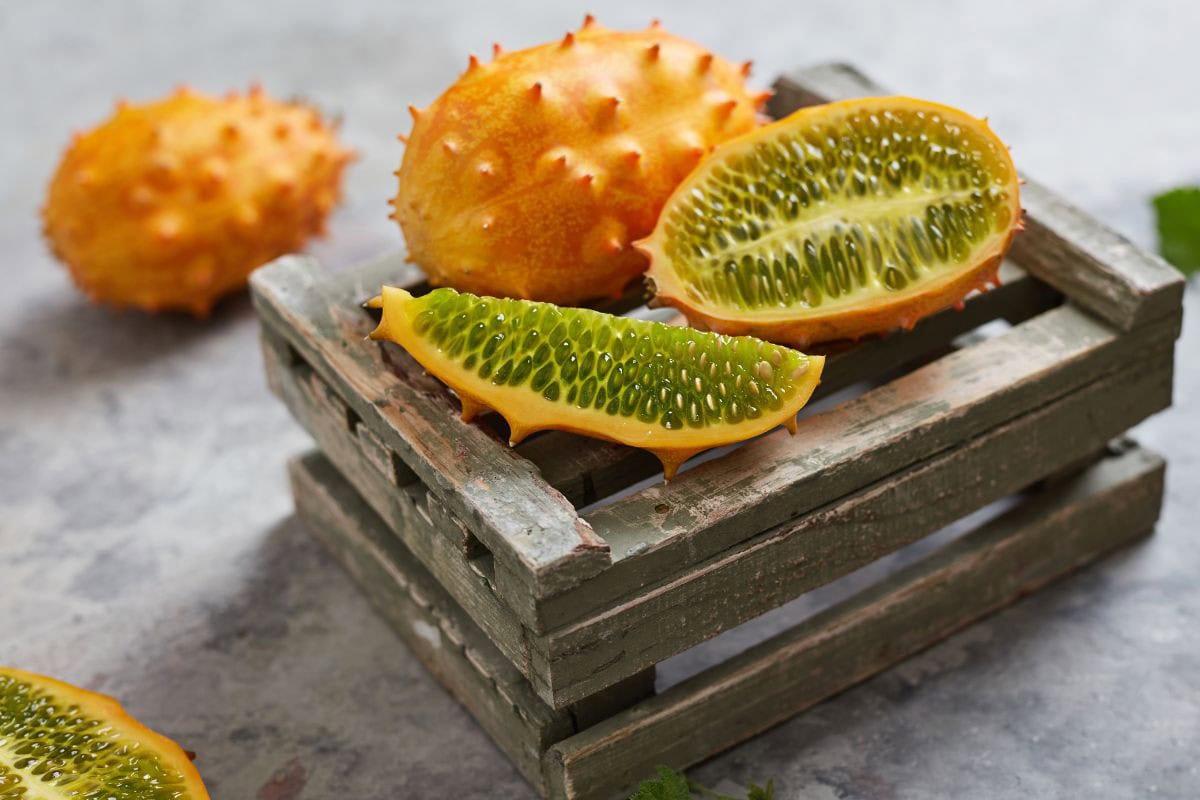 A couple of horned melons on a fruit box, one of them cut | Hurry The Food Up