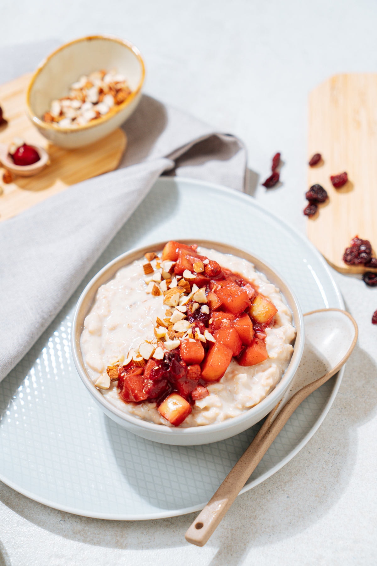 The bowl with Protein Powder Oatmeal and a spoon near it are on the white plate | Hurry The Food Up