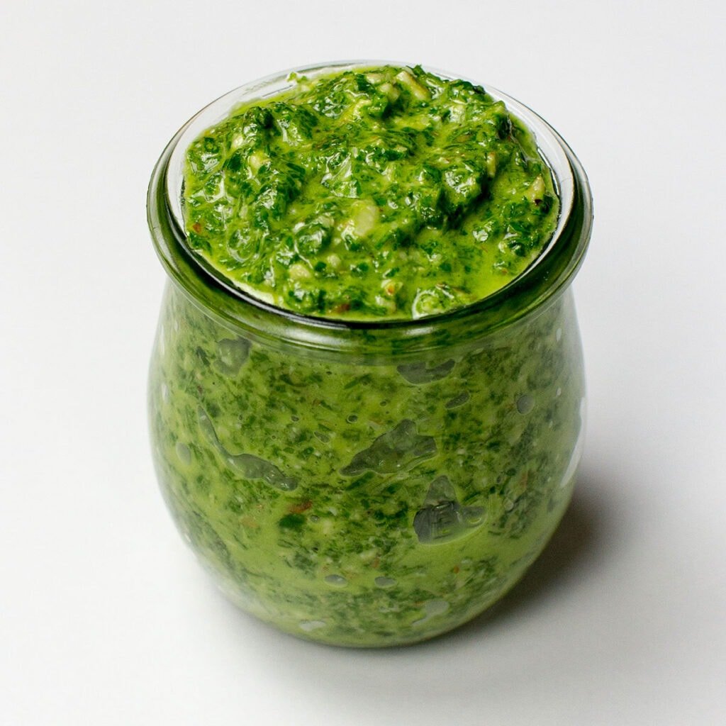 Green pesto on white background
