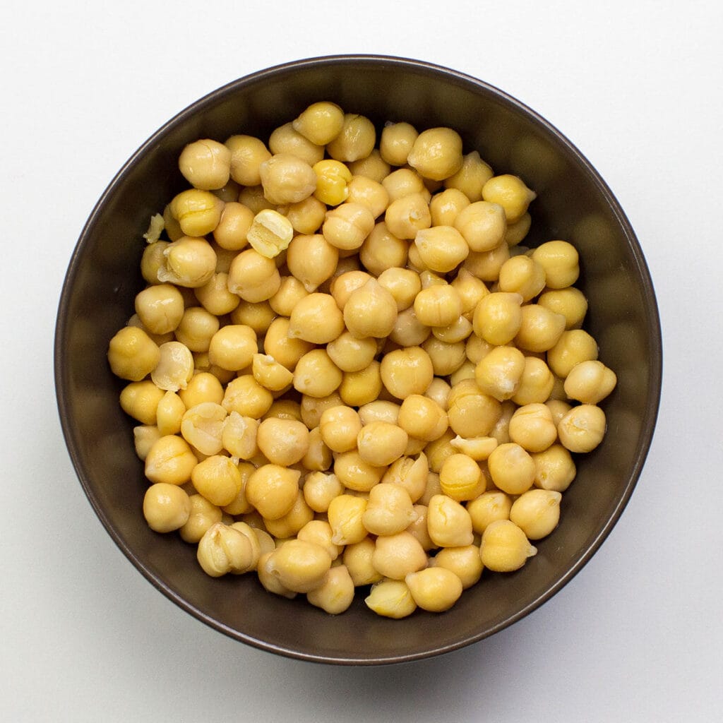 A bowl of chickpeas on white background
