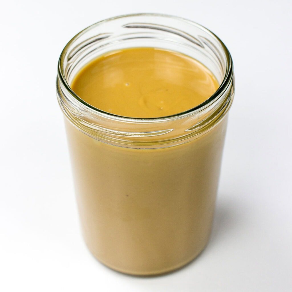 A jar of peanut butter on white surface